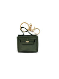 Green keychain pouch with gold clasp on a light gray background
