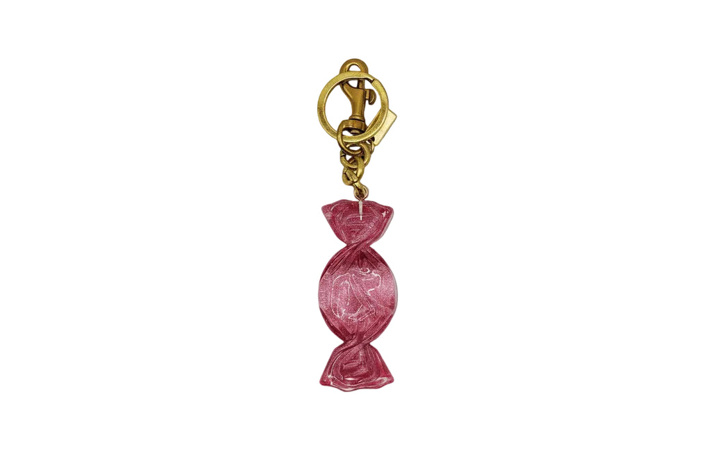 Pink candy-shaped keychain with gold clasp on a white background