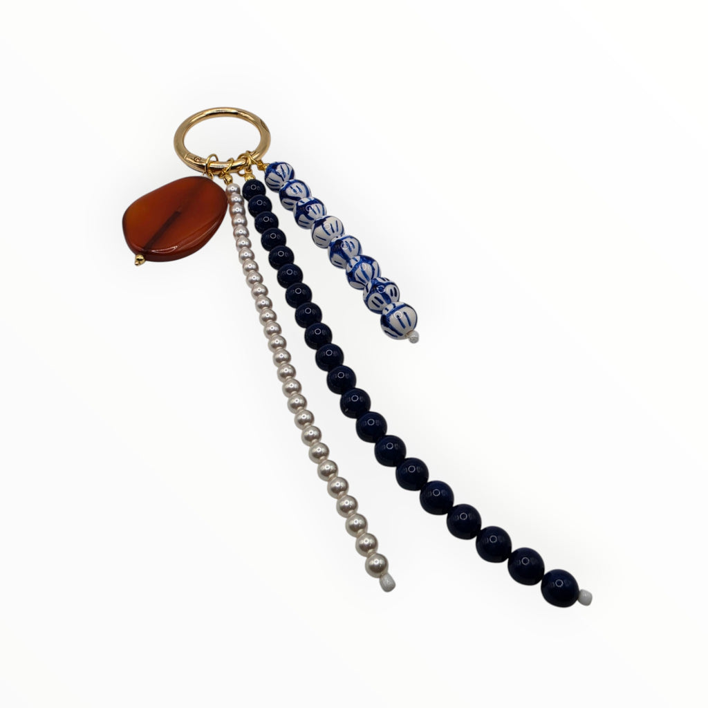 Keychain with beads and a small round object on a white background
