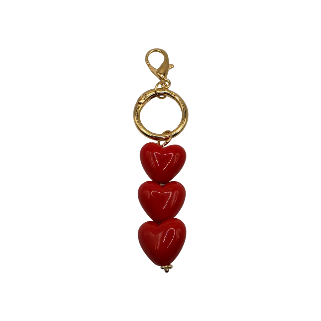 The Triple Threat Heart Charm with 3 glossy red hearts and gold-toned lobster clasp for handbags totes or keys