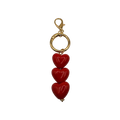 The Triple Threat Heart Charm with 3 glossy red hearts and gold-toned lobster clasp for handbags totes or keys