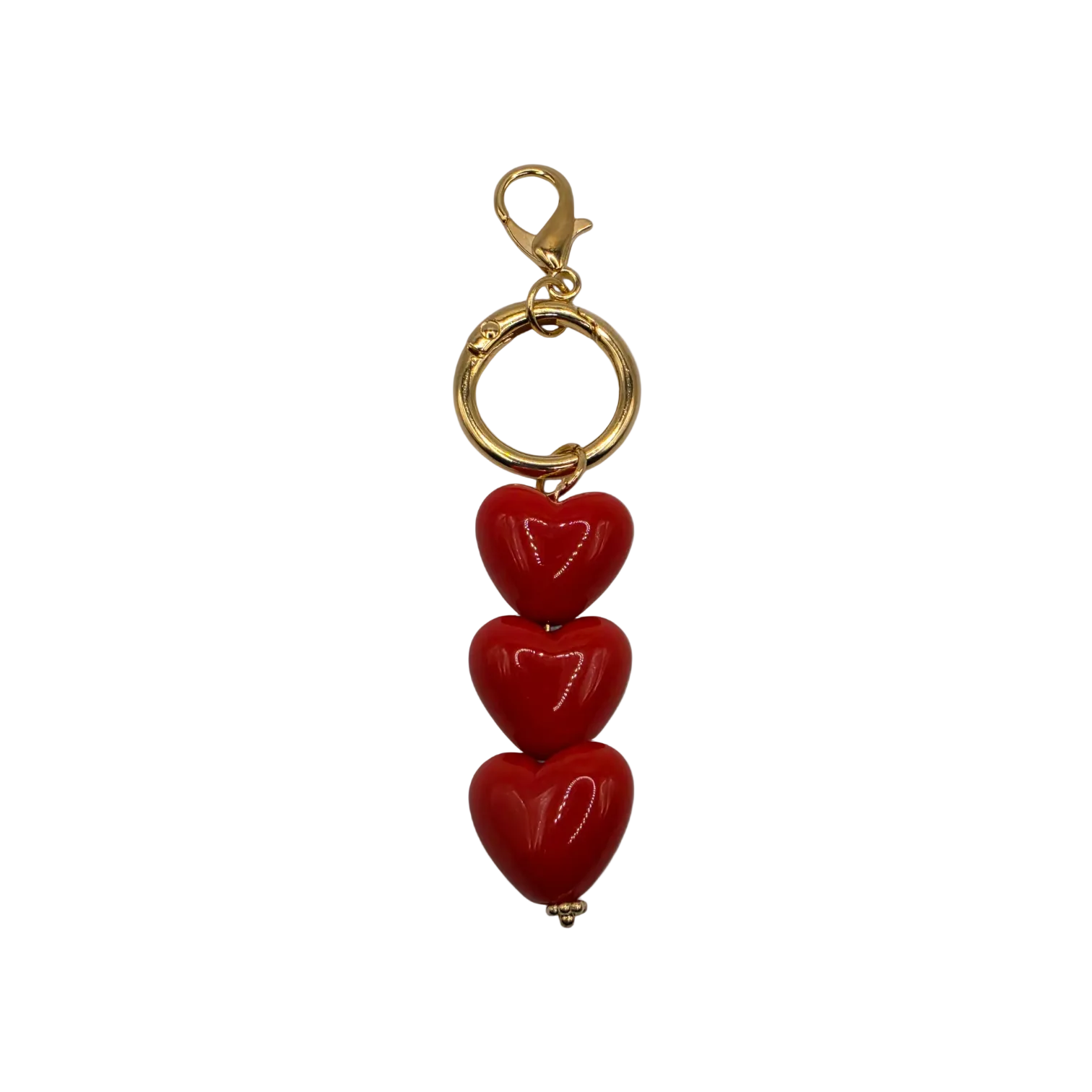 The Triple Threat Heart Charm with 3 glossy red hearts and gold-toned lobster clasp for handbags totes or keys