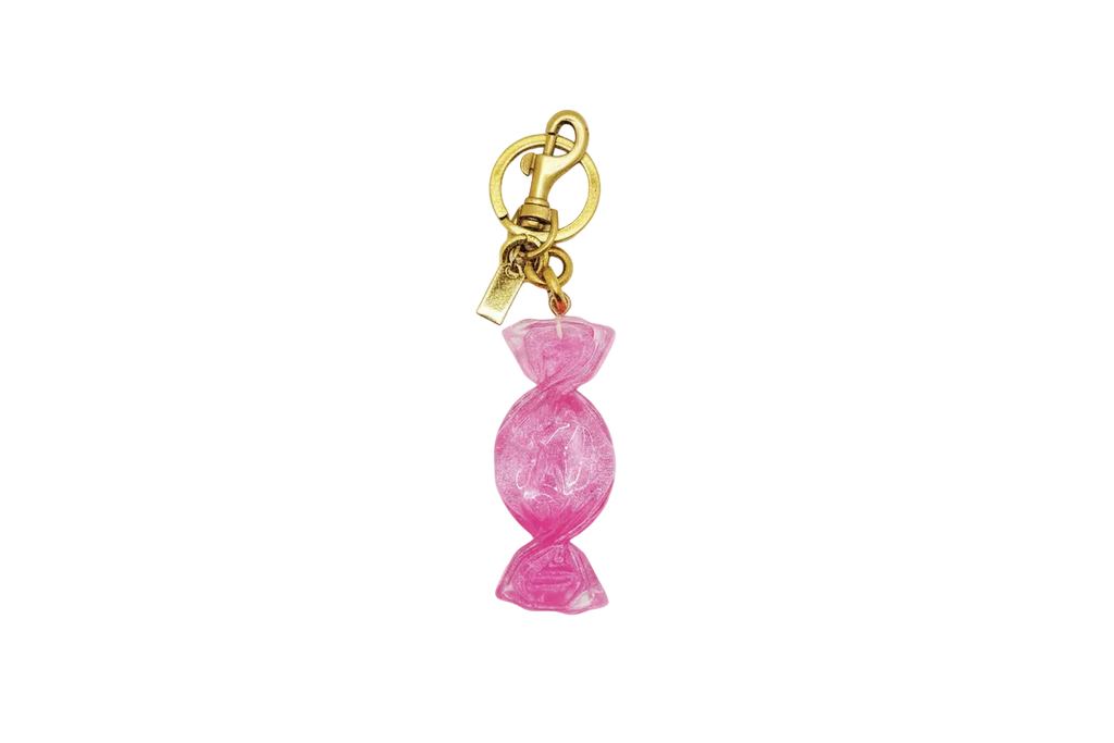 Pink candy-shaped keychain with gold clasp on a white background