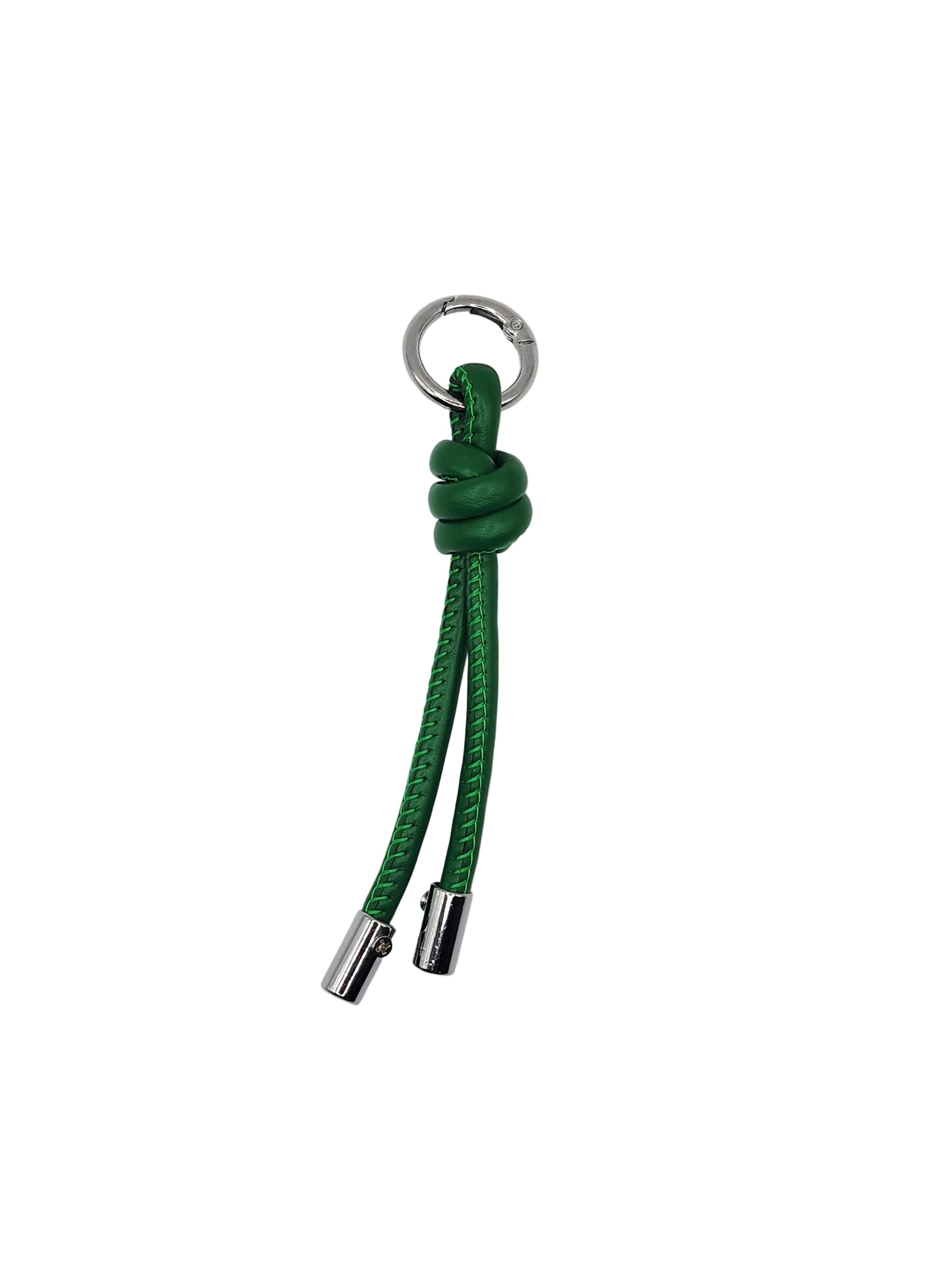 Green knotted keychain with silver clasp on a white background