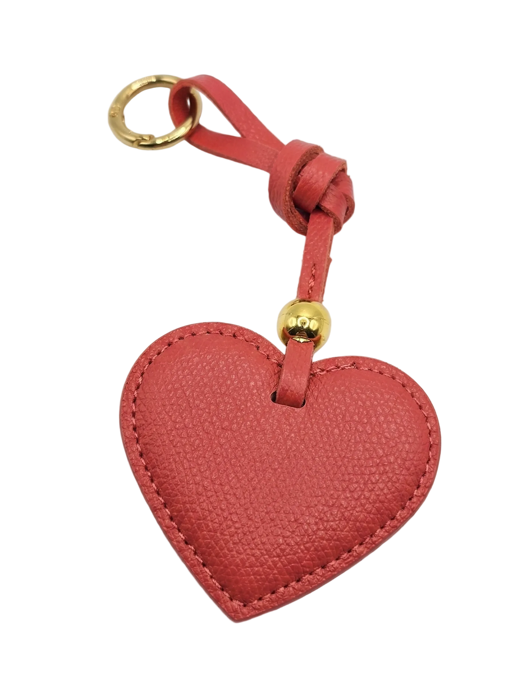 Red heart-shaped keychain with a gold ring on a white background