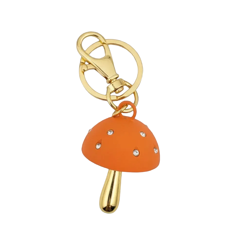 Orange mushroom-shaped keychain with gold accents on a white background