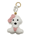 White dog-shaped keychain with a pink bow on a white background