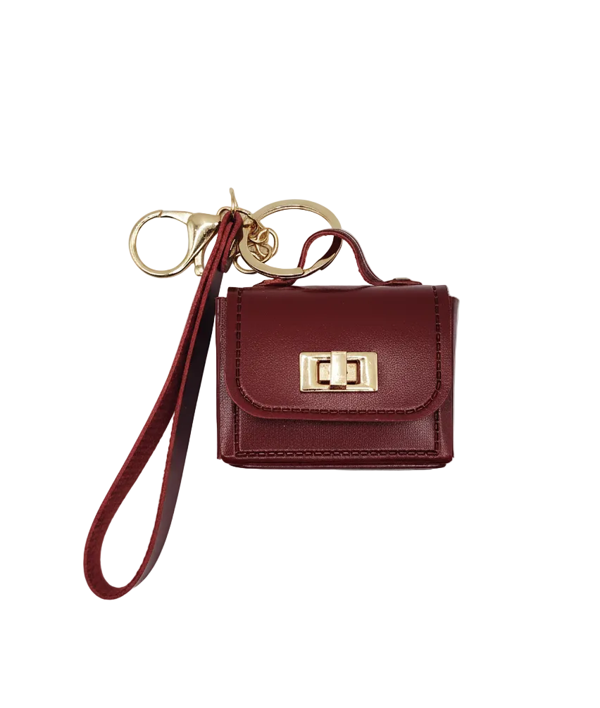 Red wristlet with gold clasp on a light gray background