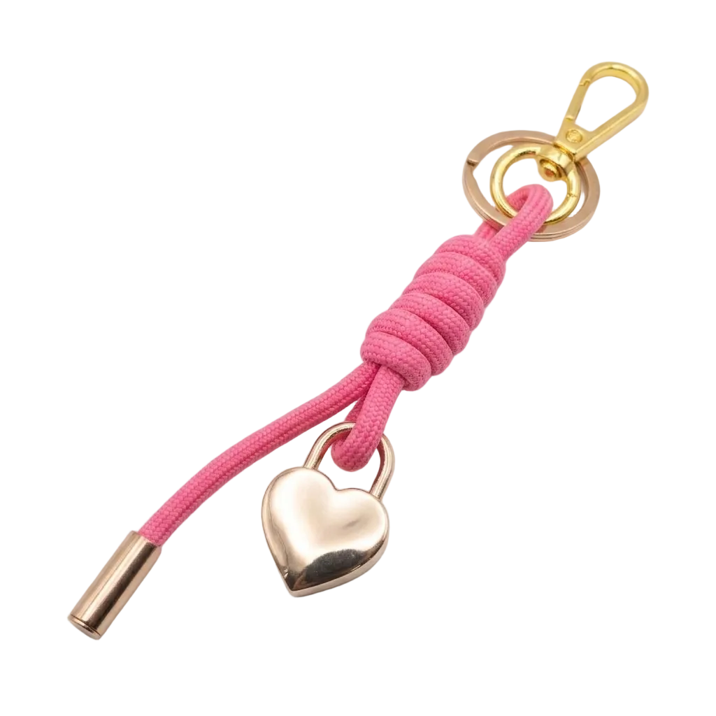 Pink keychain with gold heart lock charm on a white background